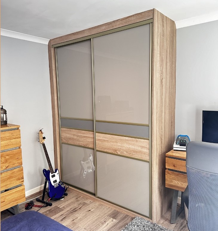 Stone grey coloured glass doors with an oak-effect frame and matching insert band in Ystrad Mynach