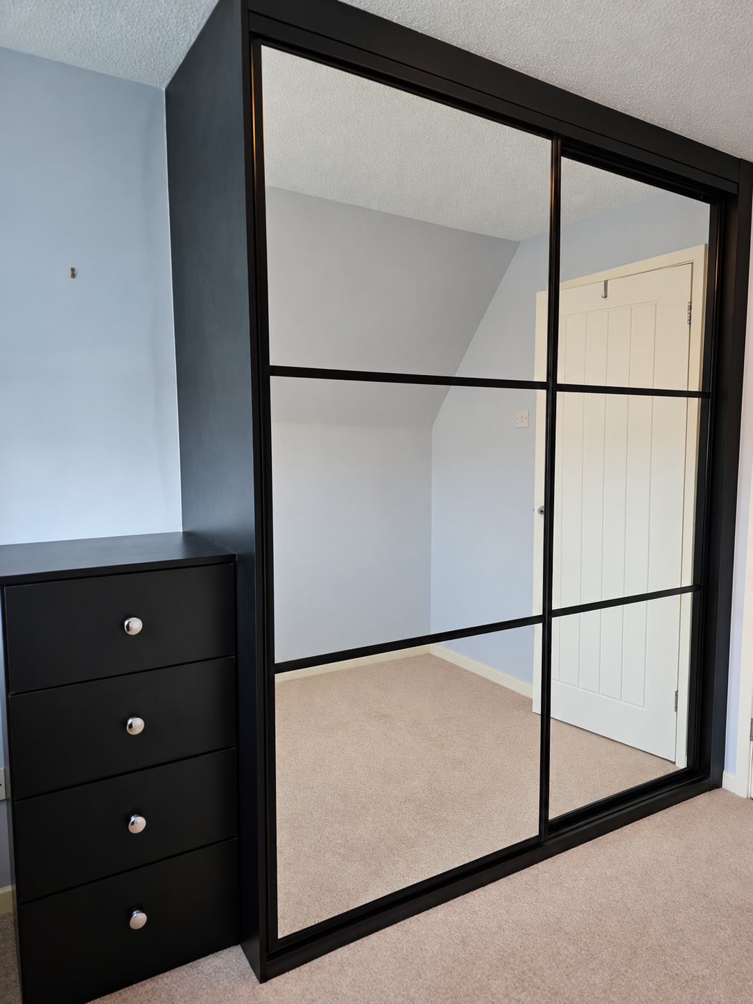 Black-framed mirror sliding wardrobe doors in Bridgend