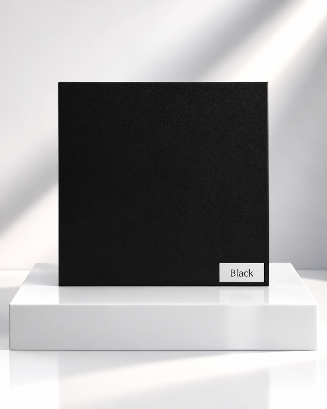 Black solid wardrobe panel sample on a white plinth
