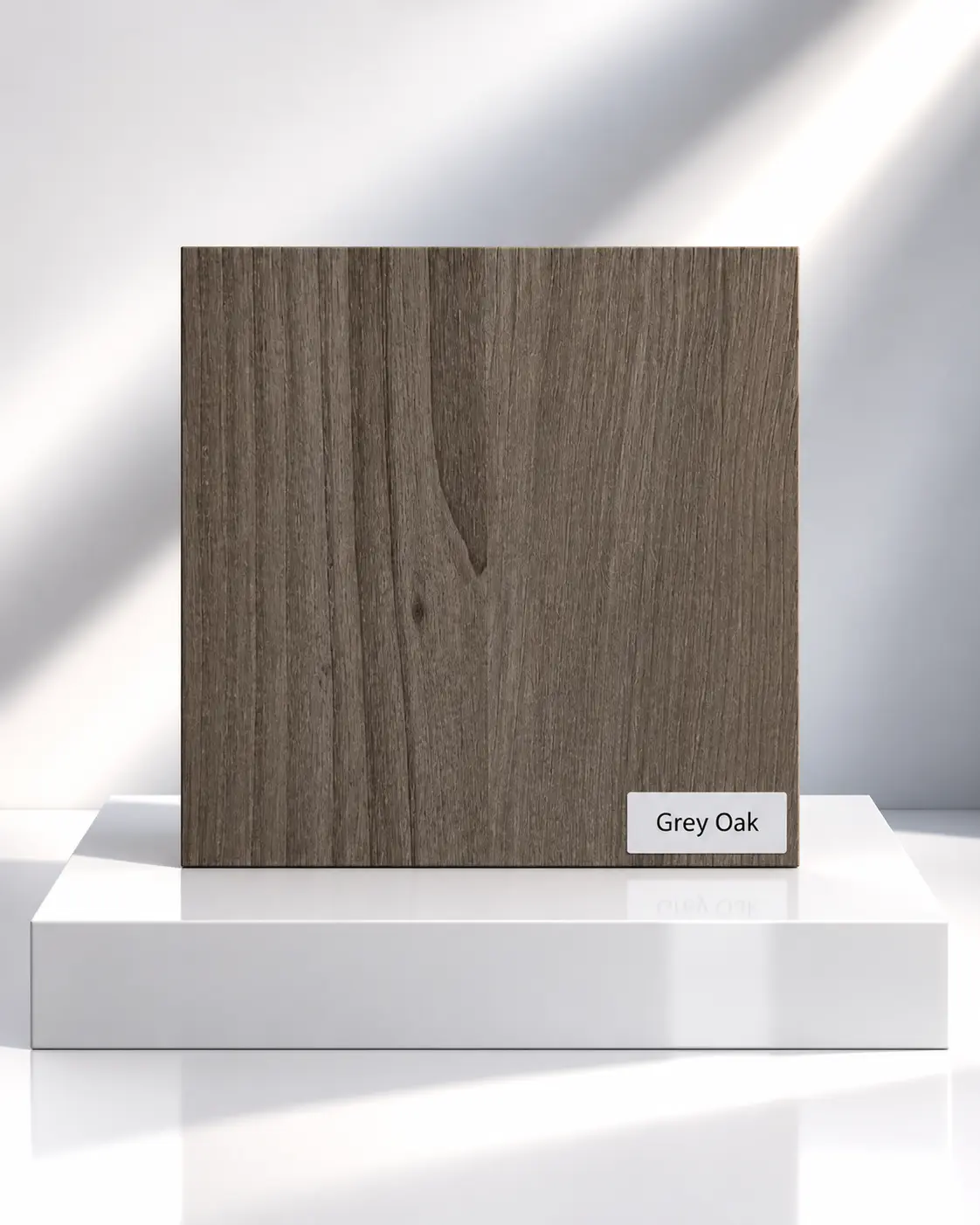 Grey Oak wood-effect wardrobe panel sample with vertical grain on a white plinth