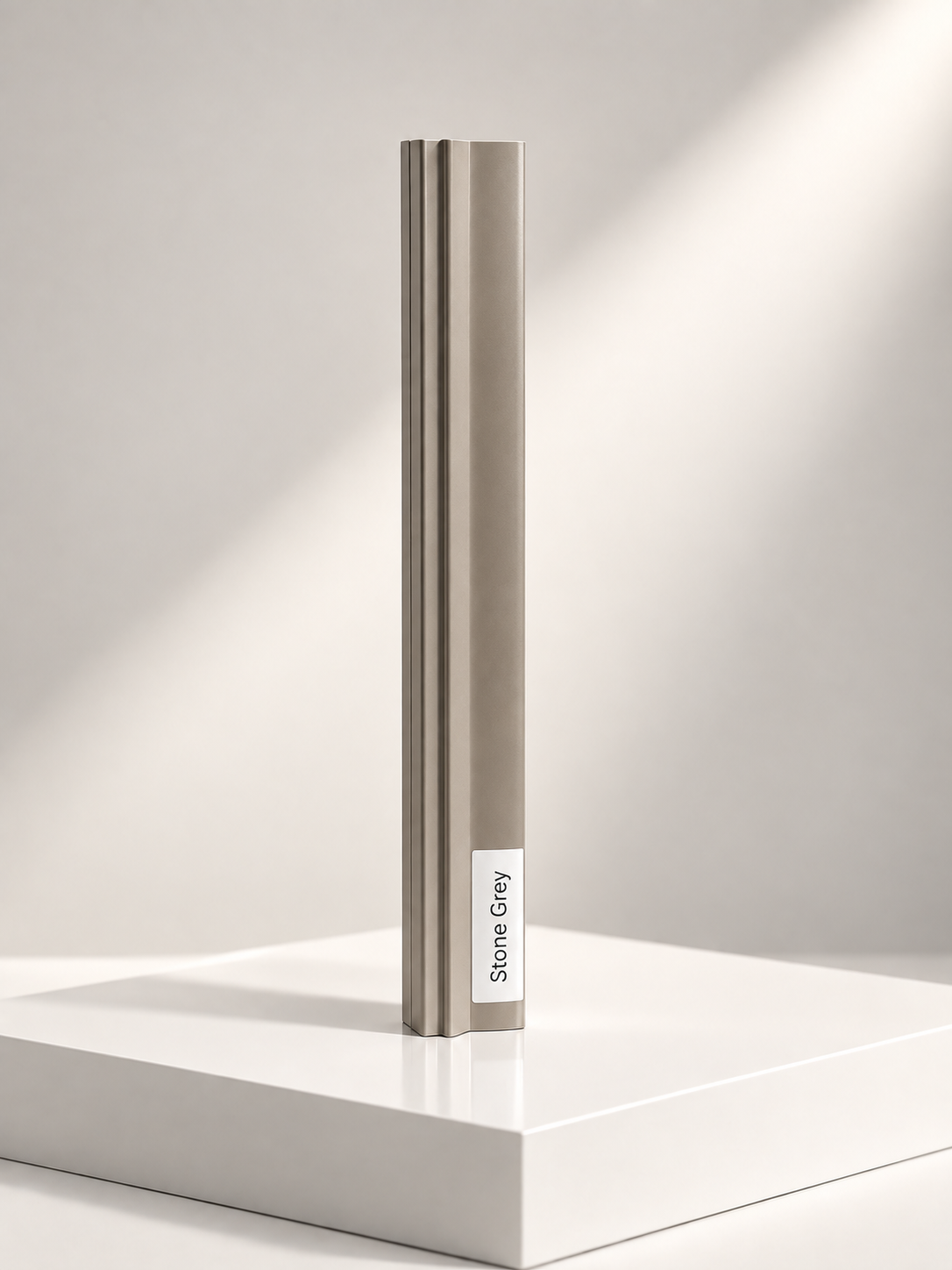 Stone grey sliding wardrobe door frame profile sample standing on a white plinth