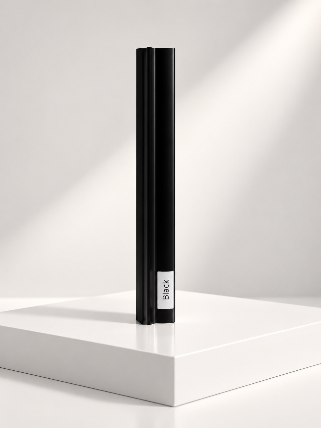 Black sliding wardrobe door frame profile sample standing on a white plinth